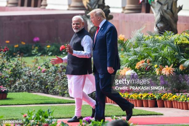 President Donald Trump and India's Prime Minister Narendra Modi arrive for a joint press conference at Hyderabad House in New Delhi on February 25,...