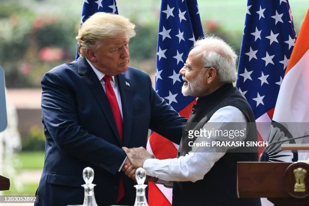 President Donald Trump shakes hands with India's Prime Minister Narendra Modi during a joint press conference at Hyderabad House in New Delhi on...