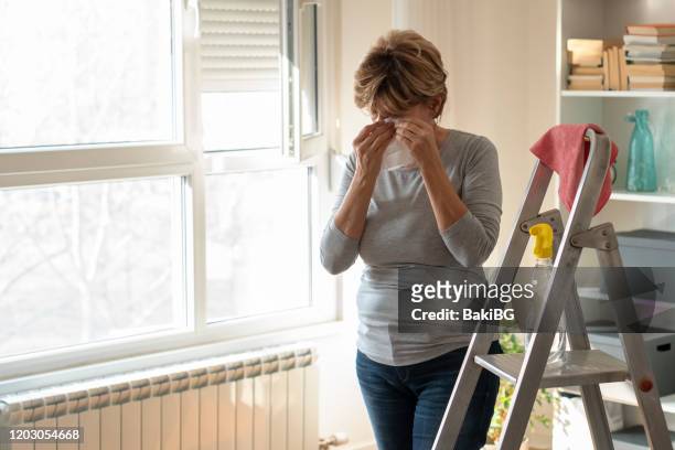 senior  woman cleaning home - allergies indoors stock pictures, royalty-free photos & images