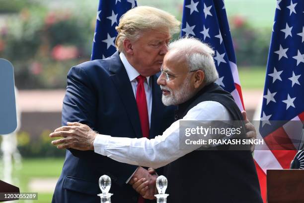 President Donald Trump shakes hands with India's Prime Minister Narendra Modi during a joint press conference at Hyderabad House in New Delhi on...