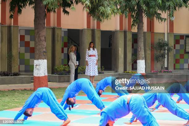 First Lady Melania Trump looks at students practising yoga during her visit at Sarvodaya Co-Ed Senior Secondary School, in New Delhi on February 25,...