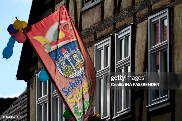 Carnival flag hangs at a house on February 25, 2020 in Volkmarsen near Kassel, central Germany. - A car that rammed into a carnival procession in...