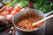bolognaise sauce in pot with ingredients background