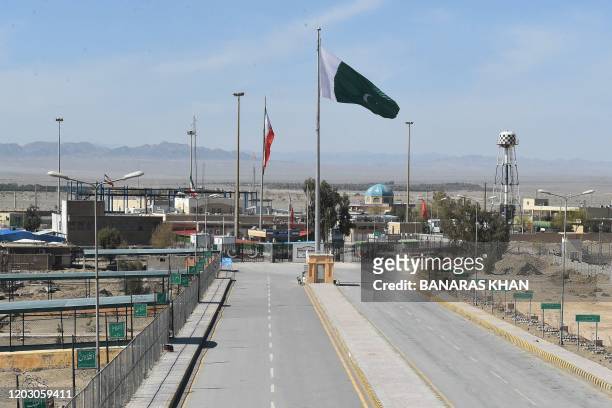 Pakistani and Iranian flags flutter on the closed Pakistan-Iran border in Taftan on February 25, 2020 as fears over the spread of the COVID-19...