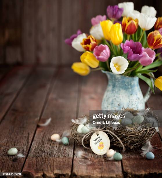 vintage easter tulips and easter eggs on an old wood background - food photography dark background blue stock pictures, royalty-free photos & images