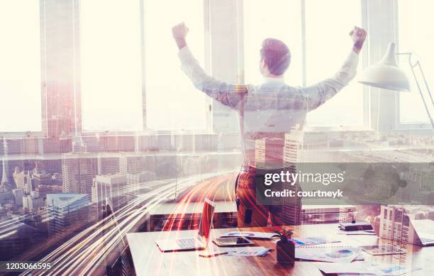 businessman celebrating with arms outstretched. - man double exposure profit concept stock pictures, royalty-free photos & images