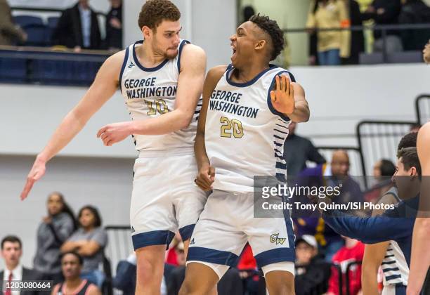 Jamison Battle and Ace Stallings of George Washington celebrate a four overtime GW win during a game between Davidson and George Wshington at Charles...