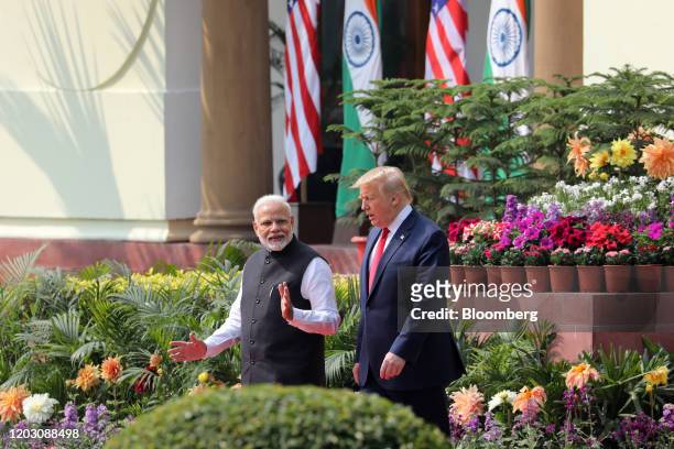 Narendra Modi, India's prime minister, left, and U.S President Donald Trump, arrive for a news conference at Hyderabad House in New Delhi, India, on...