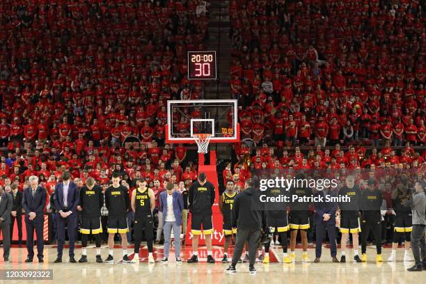 Iowa Hawkeyes players stand for a moment of silence for former NBA player Kobe Bryant who died in a helicopter crash before playing against the...