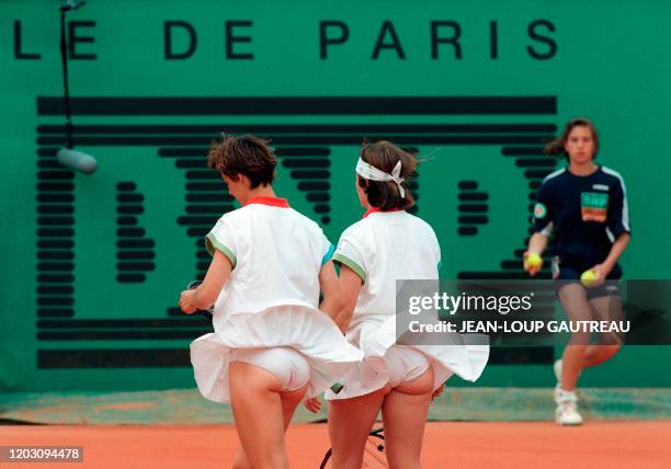 The wind uncovers the panties of French women's double team Julie Halard and Nathalie Tauziat during their French Open semifinal match against...