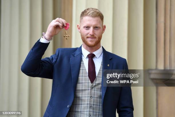 Cricketer Ben Stokes poses with his OBE that he was awarded for service to cricket, following an investiture ceremony at Buckingham Palace on...