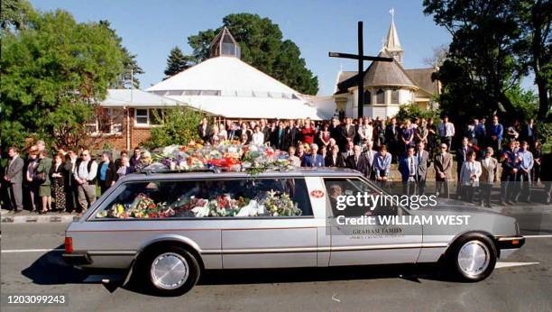 Mourners watch as the hearse carrying the coffin of bus driver Royce Thompson leaves for the cemetery in Hobart 03 May. Thompson was one of the...