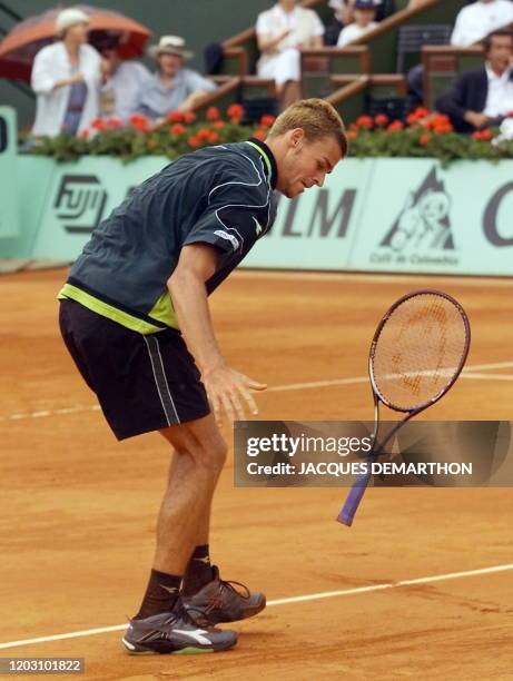 Brazilian Gustavo Kuerten throws down his racket after losing a point to Andrei Medvedev of the Ukraine during their quarter-final French Open match...