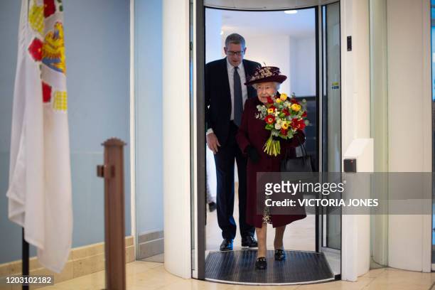 Britain's Queen Elizabeth II walks with Director General Andrew Parker during her visit to the headquarters of MI5, Britain's domestic security...