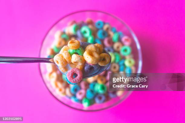 colorful breakfast cereal fills spoon - frühstücksflocken stock-fotos und bilder