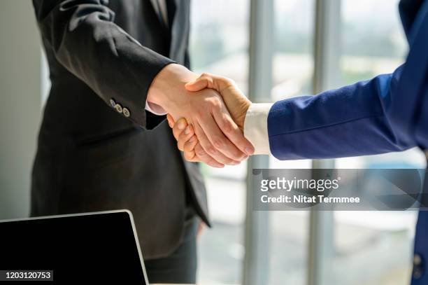 close-up of business handshake deal success concept. - handshake stock pictures, royalty-free photos & images