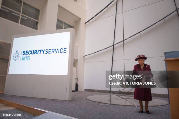 Britain's Queen Elizabeth II reacts during her visit to the headquarters of MI5, Britain's domestic security agency, at Thames House in London on...