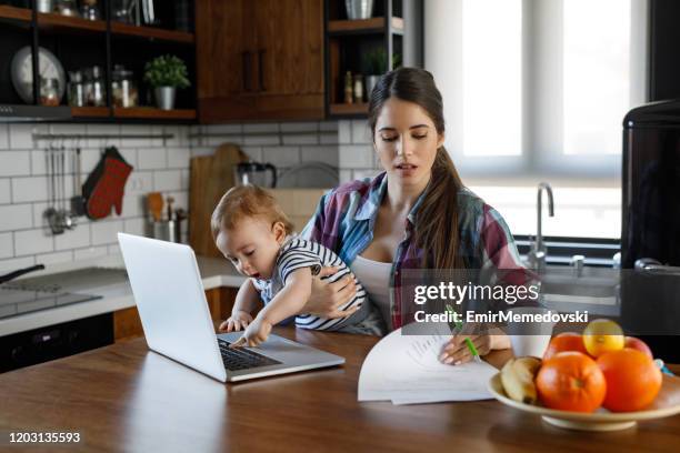 young mother juggling work and child care - juggling stock pictures, royalty-free photos & images