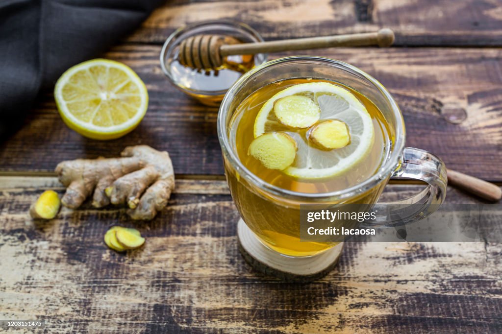 A cup of lemon ginger tea with honey