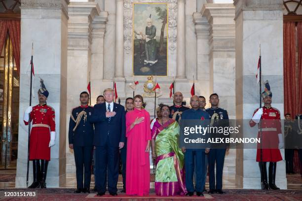 President Donald Trump and First Lady Melania Trump stand with India's President Ram Nath Kovind and his wife Savita Kovind during a state banquet at...