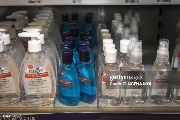 This picture taken on February 25, 2020 shows several hand sanitizing gels in a pharmacy in Amsterdam. - Since the number of coronavirus infections...