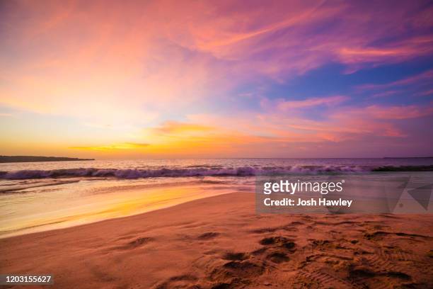 colorful sunset sky - golden sand stock-fotos und bilder