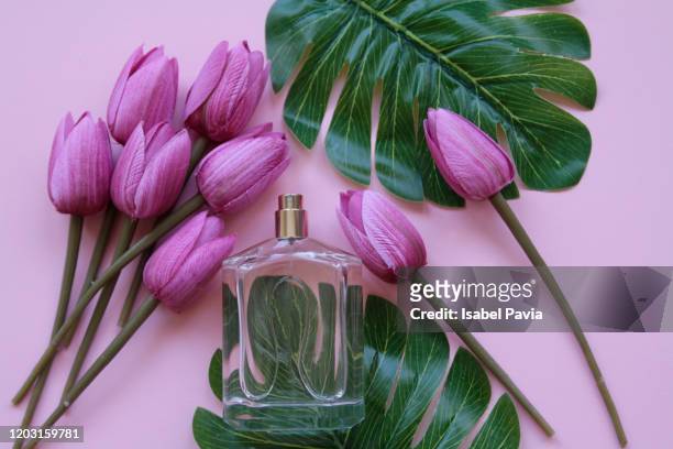 pink tulips and perfume bottle on pink background - perfume stock-fotos und bilder