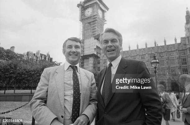 British Liberal Party politician David Steel and British Social Democratic Party politician David Owen standing before the House of Parliament in...