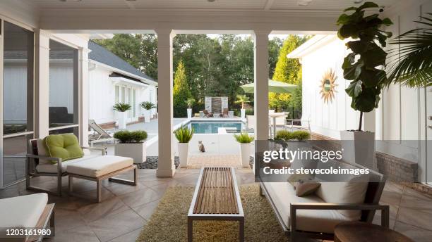 modern patio overlooking pool. - outdoor fireplace home stock pictures, royalty-free photos & images