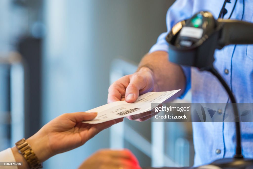 Airline attendant scanning airplane ticket