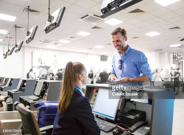 passenger doing check-in for flight at airport - crew stock pictures, royalty-free photos & images