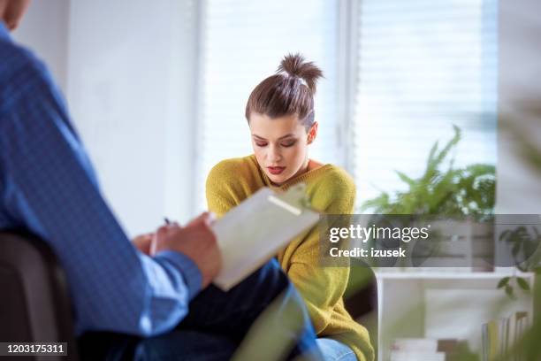 female student sharing problems with therapist - low self esteem stock pictures, royalty-free photos & images