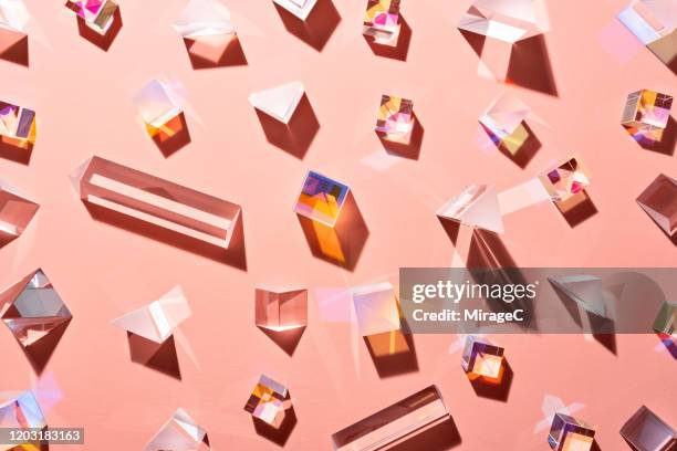 a variety of prisms on pale pink - peach colour stockfoto's en -beelden