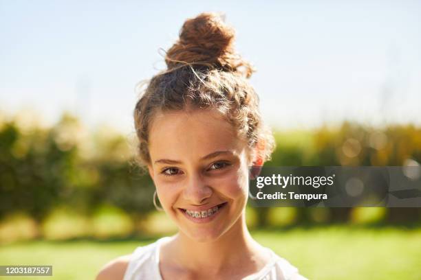 teenager outdoors smiling at camera. - brace stock pictures, royalty-free photos & images