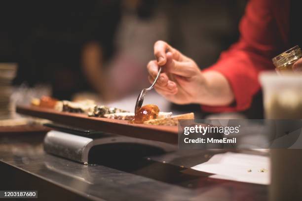 young cook preparing a cheese board - cheese board stock pictures, royalty-free photos & images