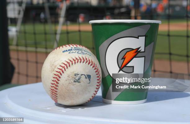 Detailed view of a Rawlings official baseball and a Gatorade cup sitting in the dugout prior to the Spring Training game between the Houston Astros...