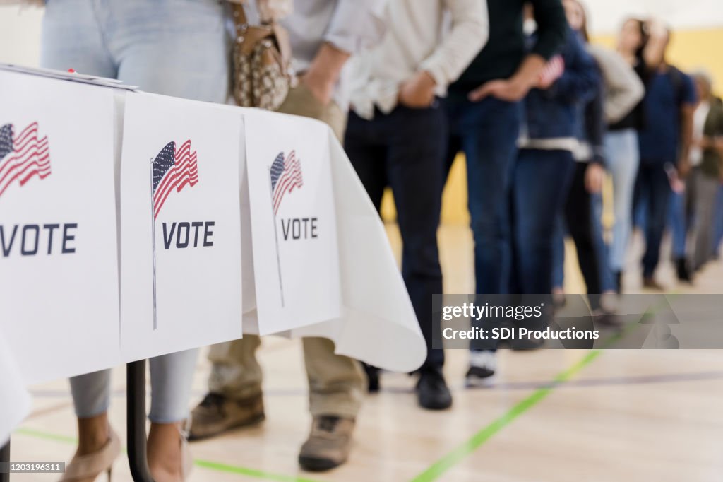 Low angle view of people lined up to vote