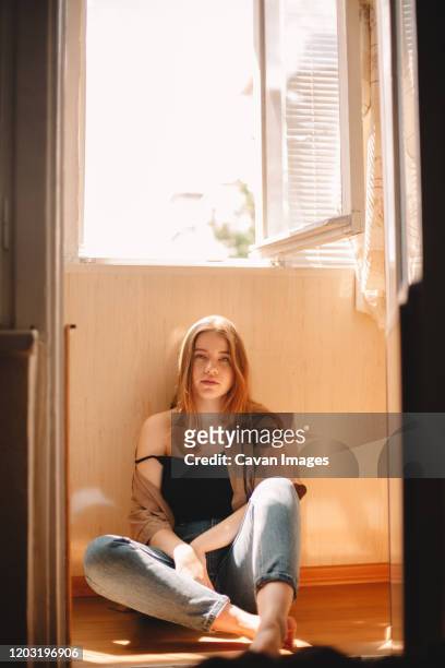 cute teenage girl sitting on floor in balcony during summer - girls open legs fotografías e imágenes de stock