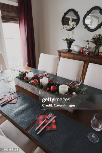 table set for a formal christmas holiday dinner in a dining room. - tischdekoration stock-fotos und bilder
