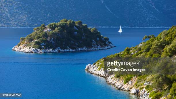 sailboat and an islet in the molos gulf in ithaca island, greece. - ithaca stock pictures, royalty-free photos & images