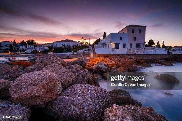 evening view of spetses village from the harbour pier, greece. - spetses stock pictures, royalty-free photos & images