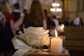 White rose and candle in a church
