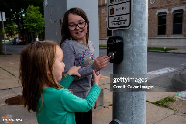 sisters playing with buttons at a stop light - center street elementary stock pictures, royalty-free photos & images