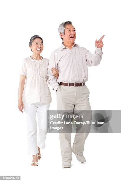 happy senior couple walking - gray hair couple stock pictures, royalty-free photos & images