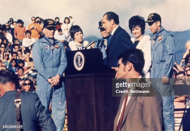 President Richard Nixon greets the Apollo 13 astronauts during arrival ceremonies. Left to right: Astronaut John Swigert, Mary Haise, Fred Haise,...
