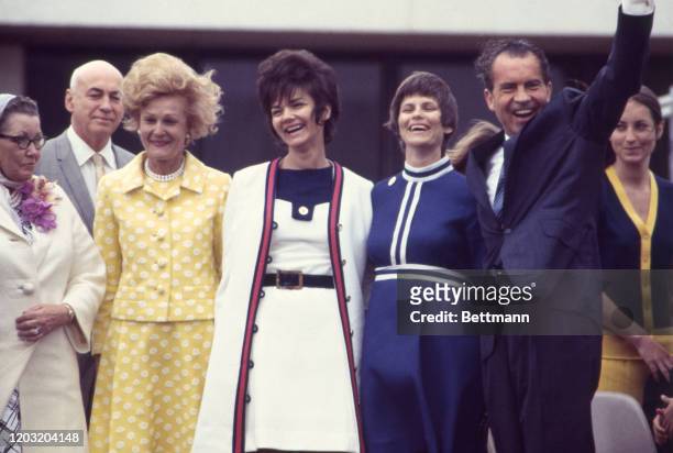 President Nixon waves as he and Mrs. Nixon stand on platform with astronauts wives and relatives the day after successful splashdown of Apollo 13 in...