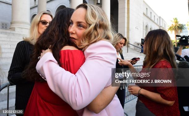 Lead plaintiff Louisette Geiss embraces Sarah Ann Masse as a group of Hollywood actresses and others part of a group of Silence Breakers who have...