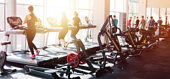 Blurred photo of a gym with people on treadmills