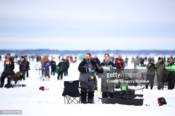 Anglers stand for the National Anthem prior to fishing on Gull Lake during the Brainerd Jaycees Ice Fishing Extravaganza on January 25, 2020 in...