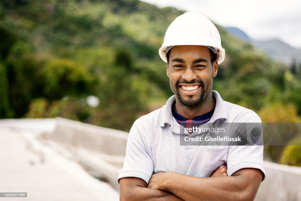 Construction worker looking at camera, using safety equipments